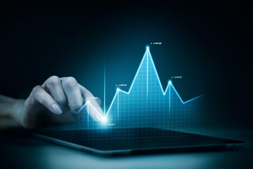 An image with a hand in front of a data visualization. Used for the blog What is Data Analytics?